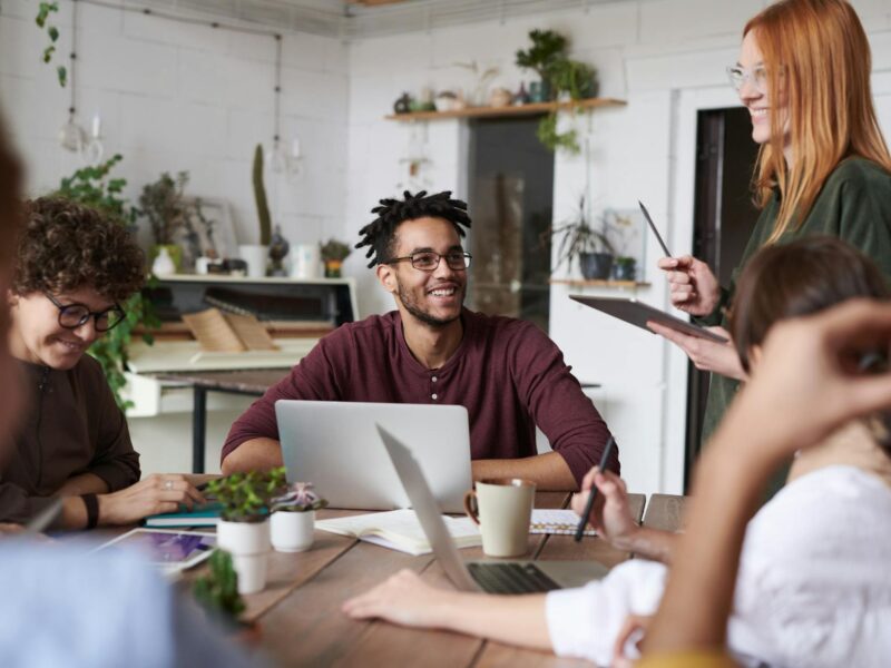 photo of people near laptops